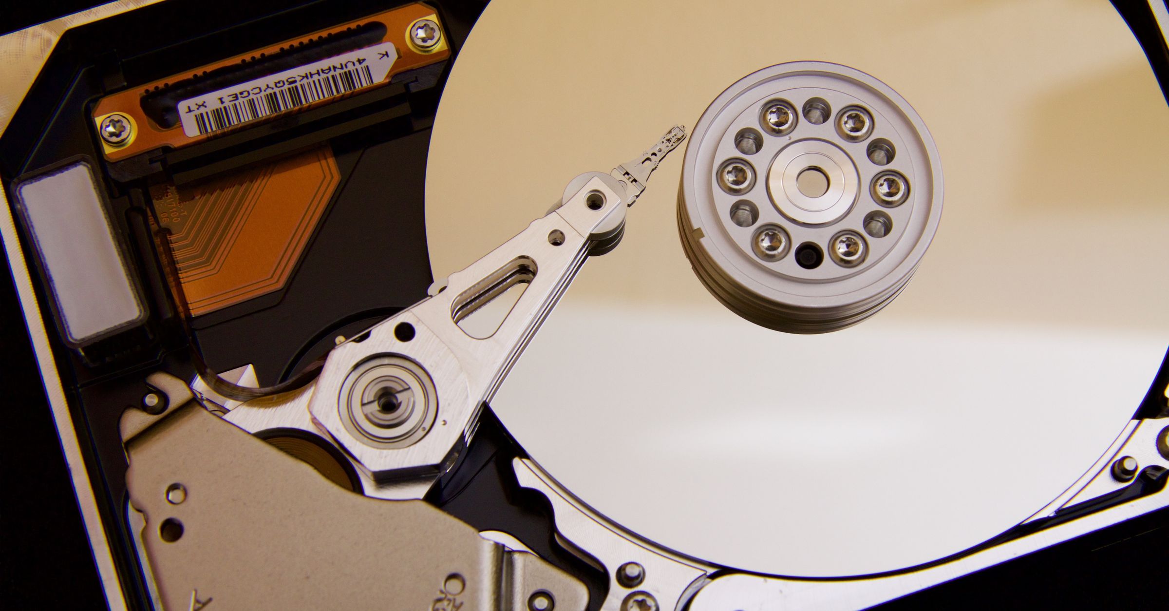 Detailed close-up of a hard disk drive showing the actuator arm and data platters.