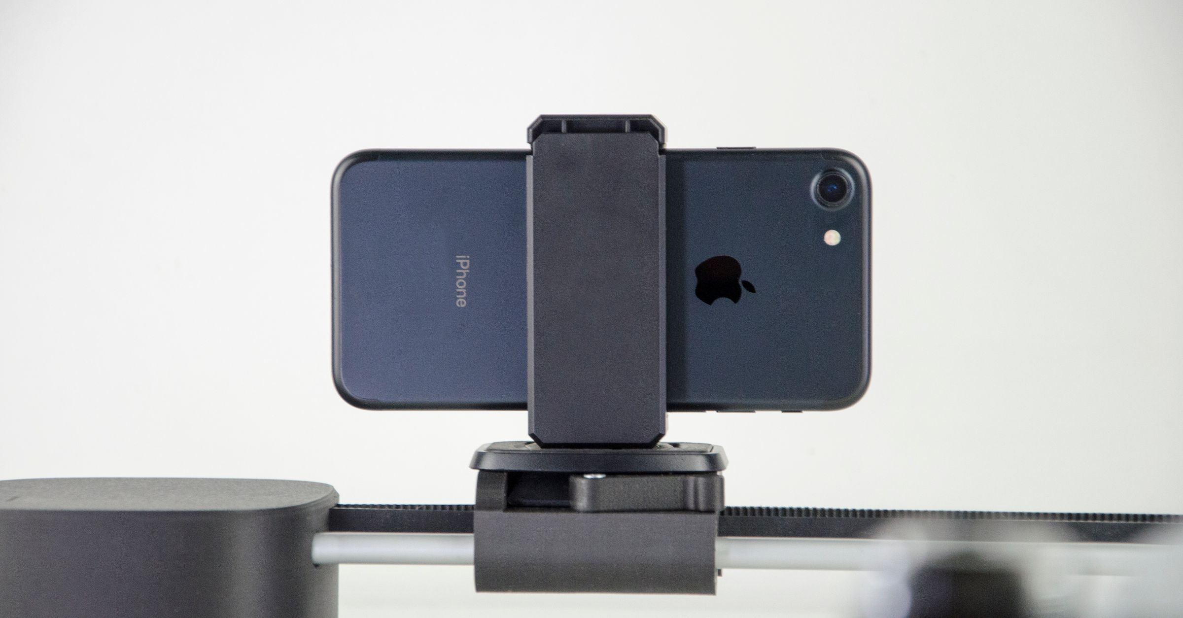 A close-up image of a smartphone mounted on a slider, ideal for video production and cinematic capturing.